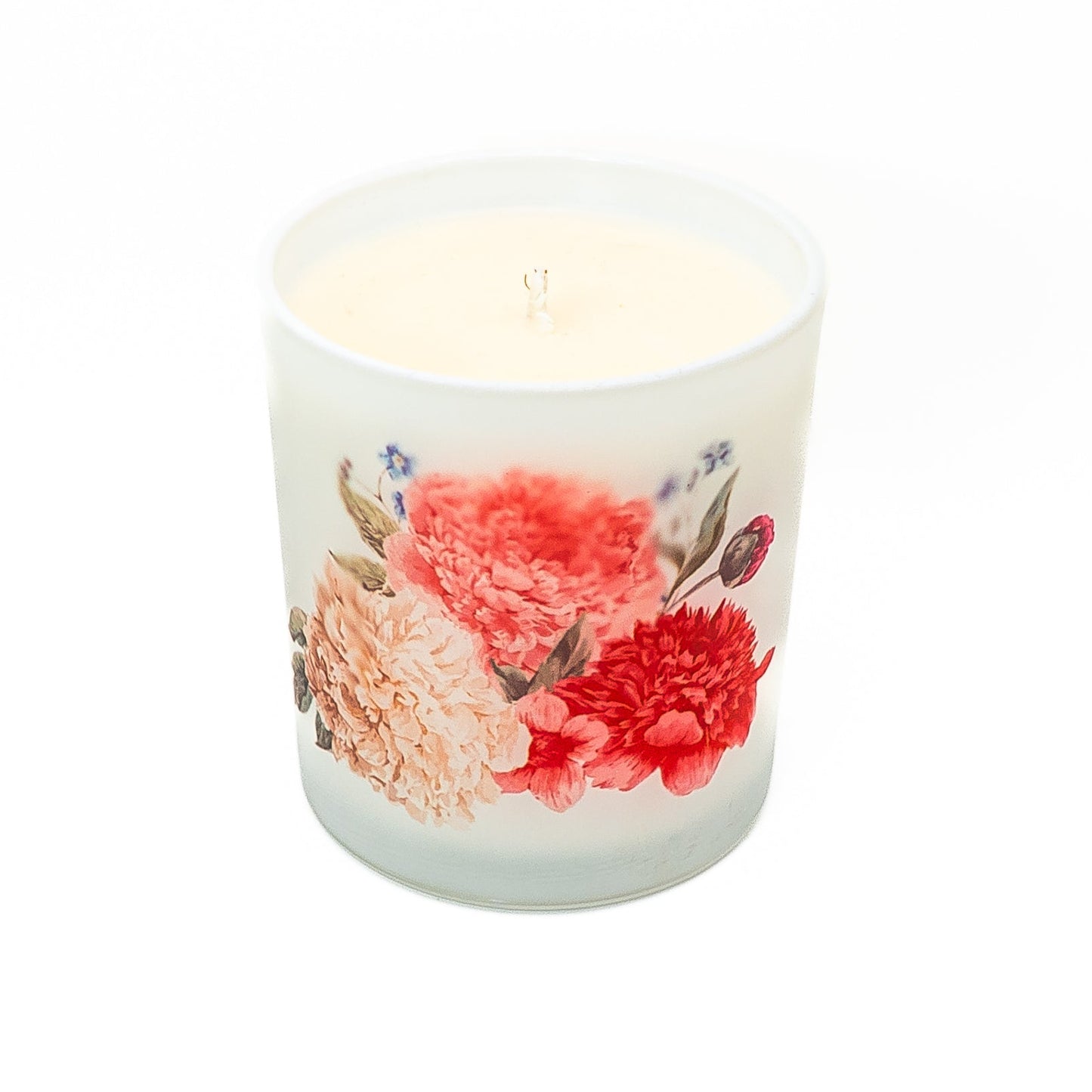 Decorative hand-poured soy wax candle in a frosted glass jar with botanical floral design.