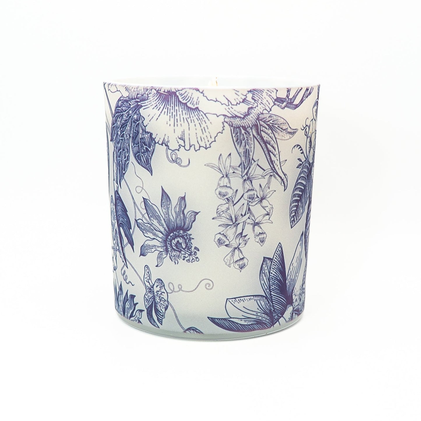 Hand-poured soy wax candle with elegant blue floral botanical design on a decorative glass container.