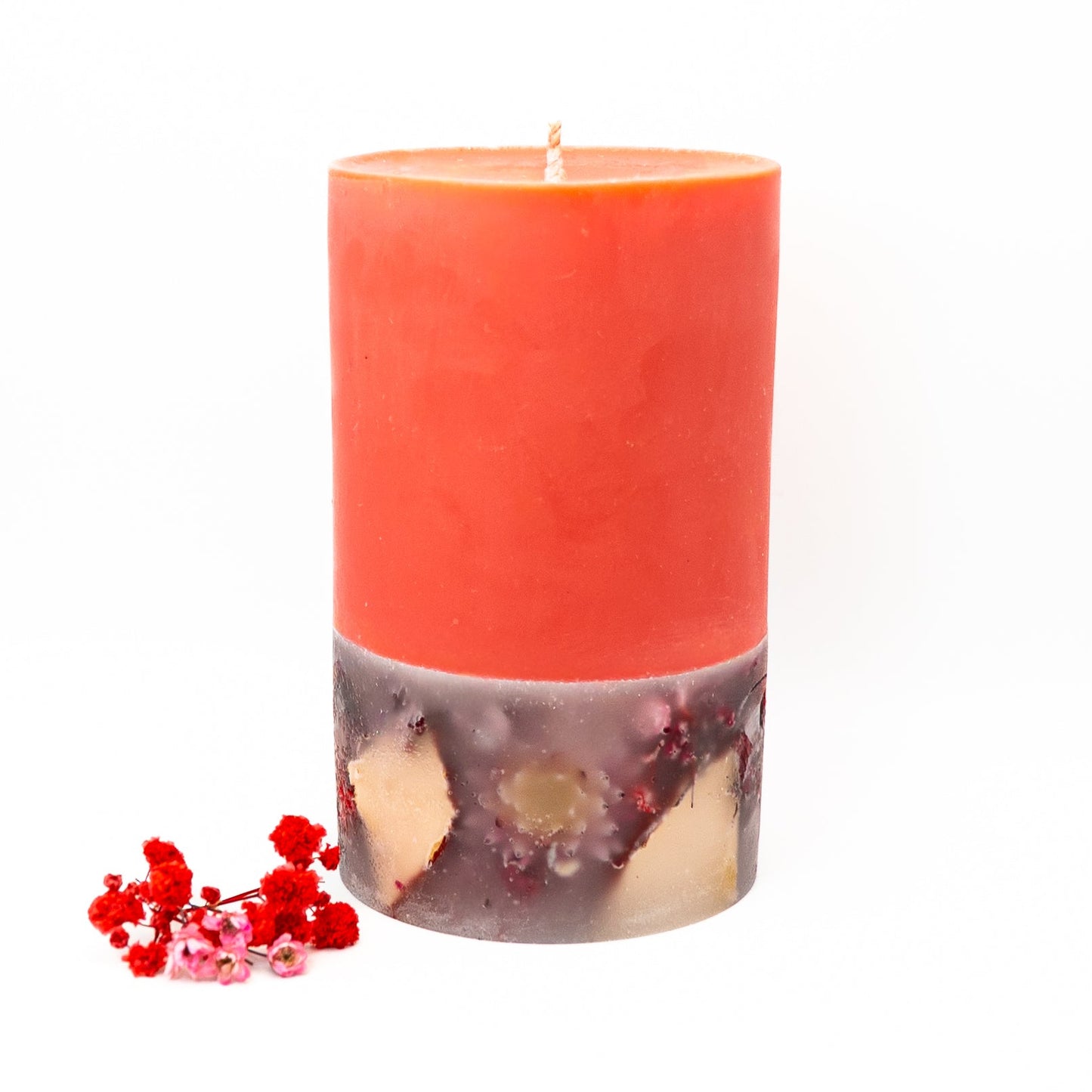 Hand-poured layered soy wax candle with red upper layer and dried flower botanicals below.