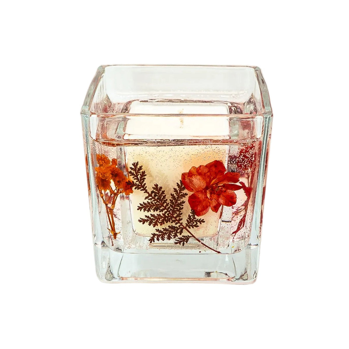 Handmade autumn botanical soy wax candle in a square glass jar