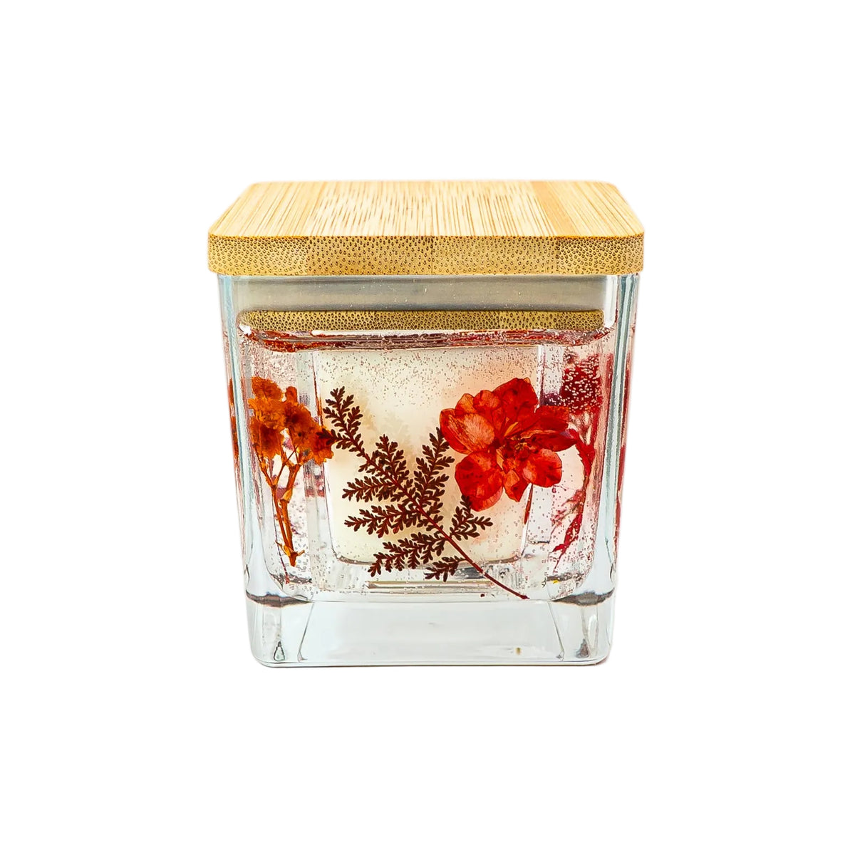 Autumn floral candle with dried flowers and foliage for seasonal home décor.