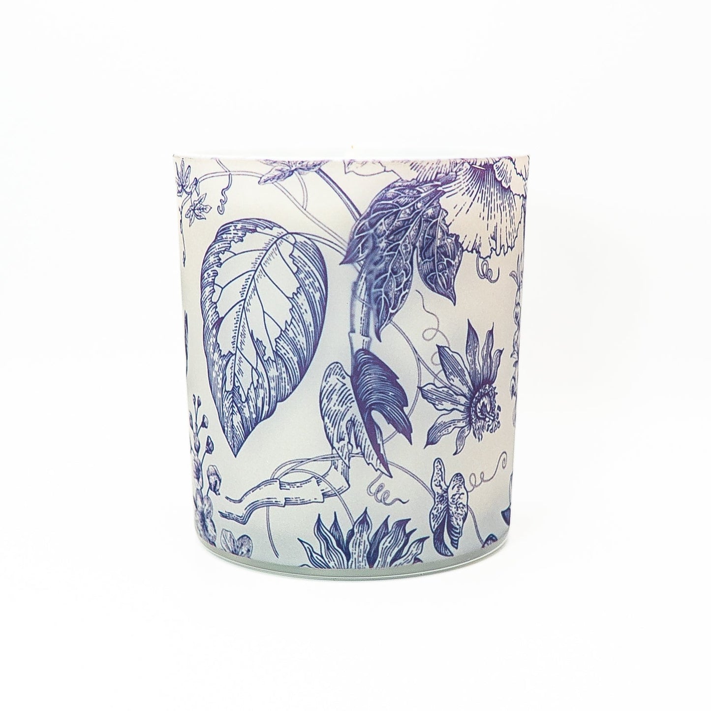 Elegant soy wax candle in a glass jar decorated with blue botanical artwork and topped with a bamboo lid.