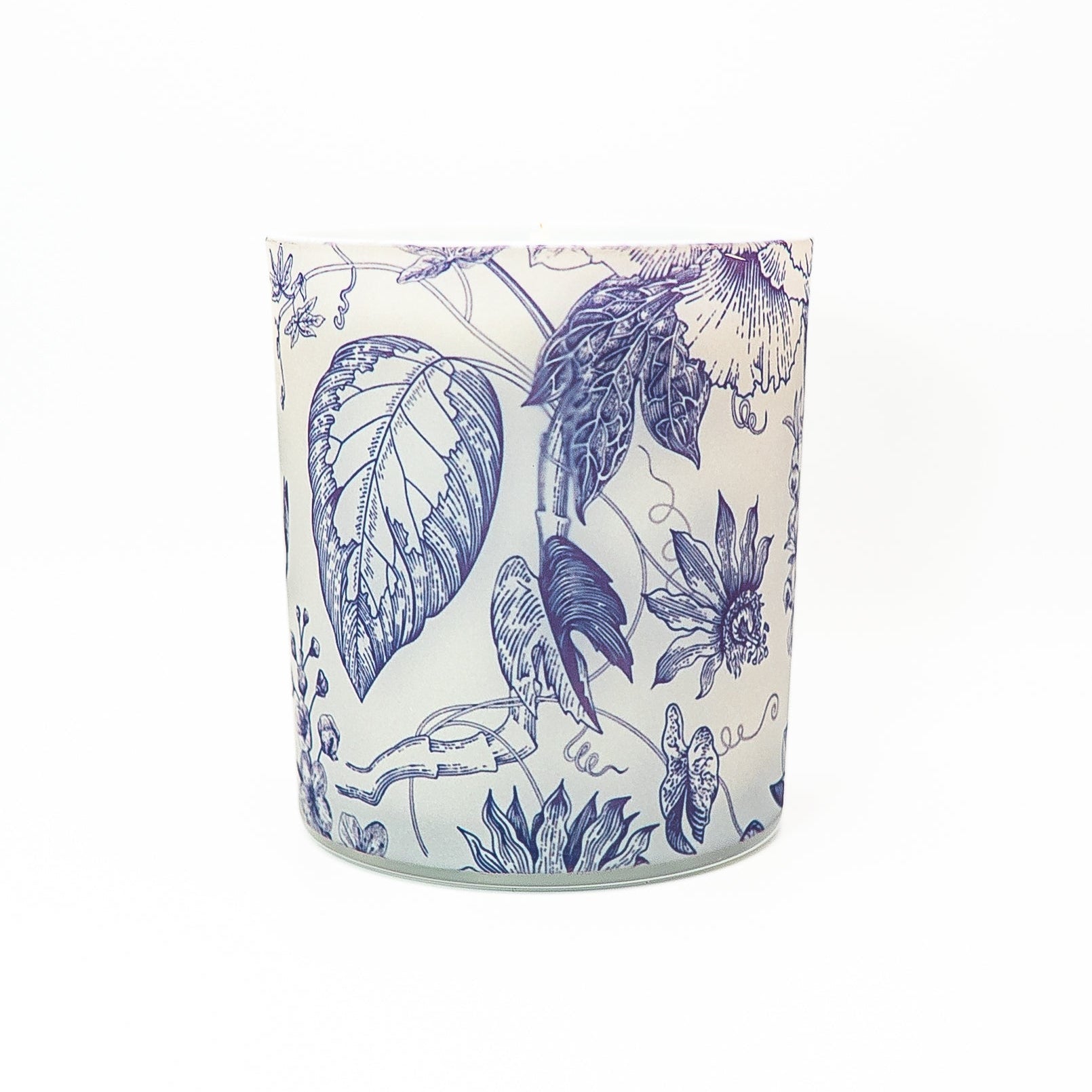 Elegant soy wax candle in a glass jar decorated with blue botanical artwork and topped with a bamboo lid.