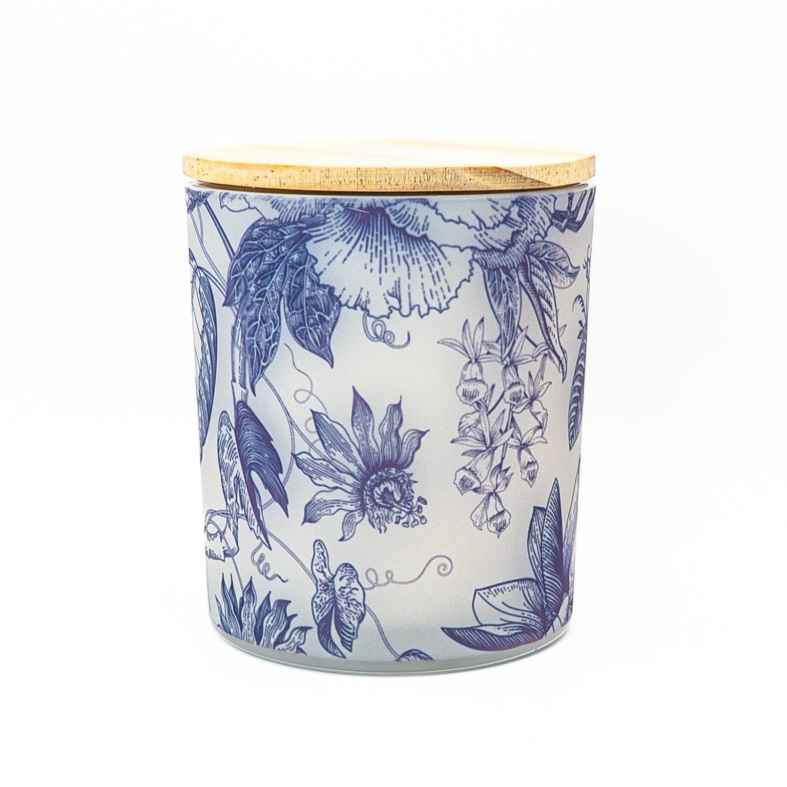 Blue botanical soy wax candle in a decorative glass jar with bamboo lid featuring elegant botanical illustrations.