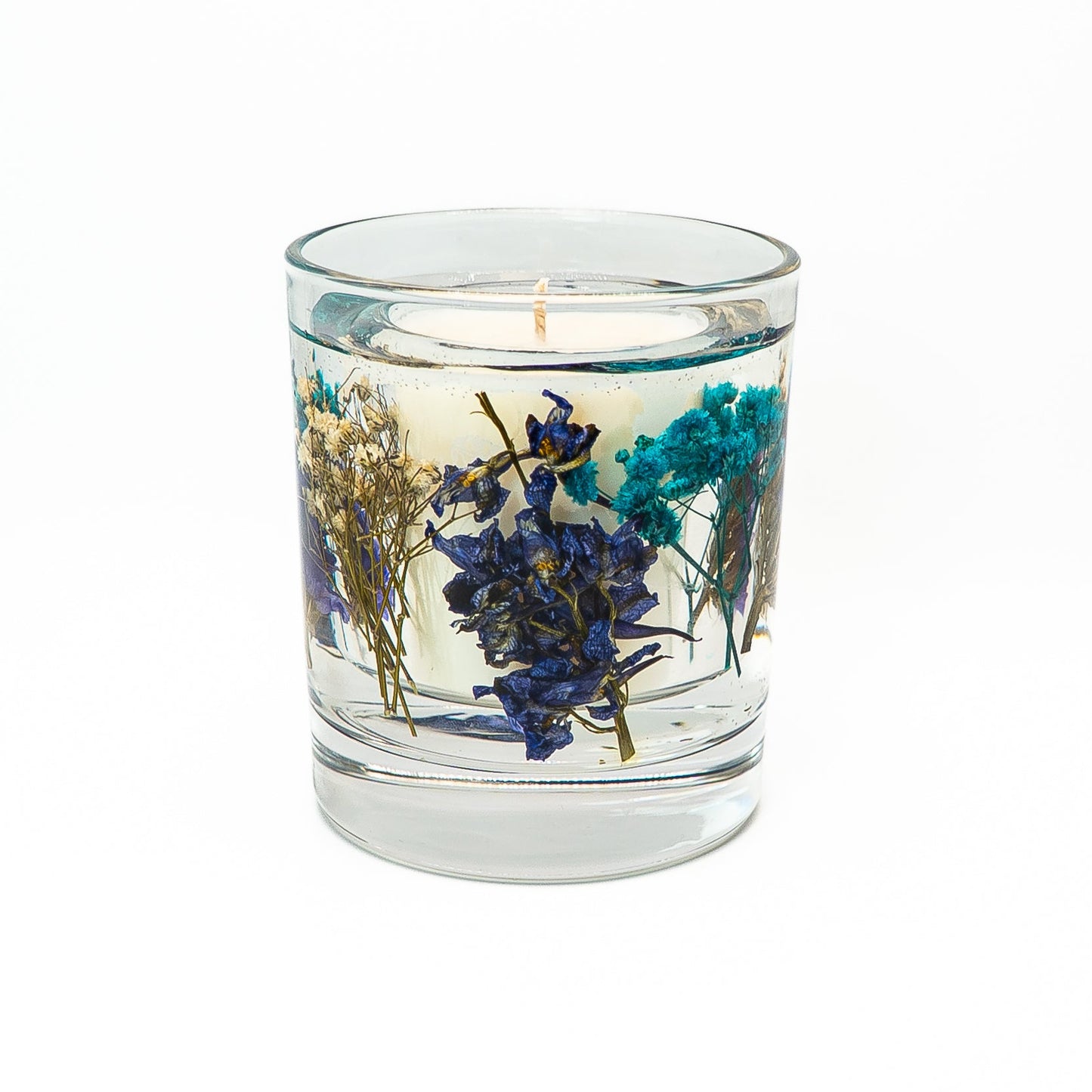 Decorative soy wax candle with clear gel wax featuring blue botanical flowers in a glass jar.