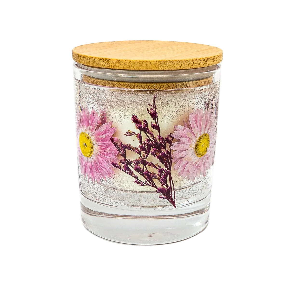 Botanical container candle with a soy wax centre and pink dried flowers in clear gel wax, finished with a wooden lid.