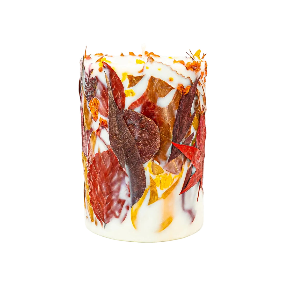 Botanical pillar candle viewed from the side, showing red autumn leaves, orange foliage and yellow flowers against cream soy wax.