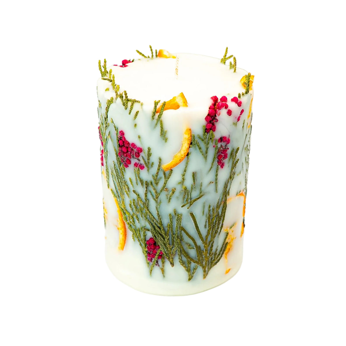 Cream soy wax Christmas candle showing red berry clusters, delicate thuja branches and dried orange embedded in the wax.