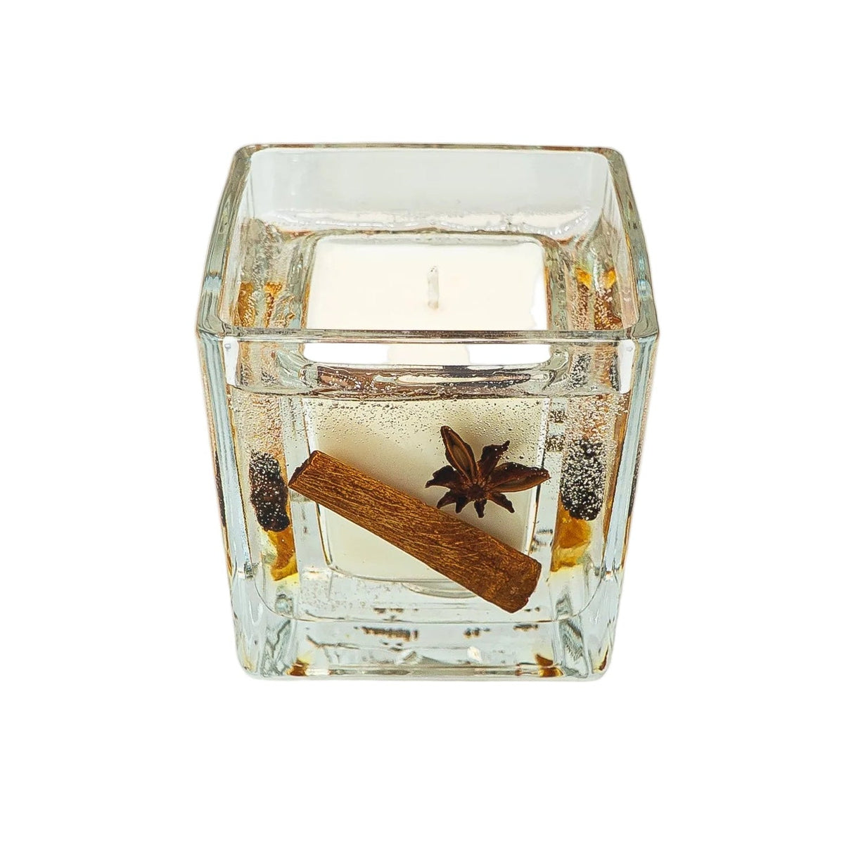 View from above of an open Christmas botanical jar candle with a single wick, cinnamon stick and star anise.