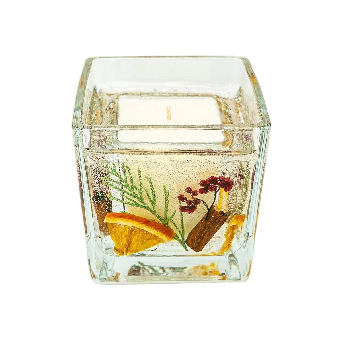 Christmas soy wax and gel candle viewed from above, showing the single wick and botanicals around the ivory wax centre.