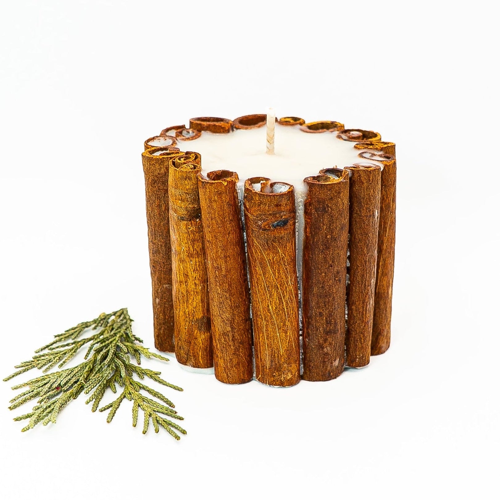 Handmade soy wax pillar candle wrapped with real cinnamon sticks for rustic winter home décor.