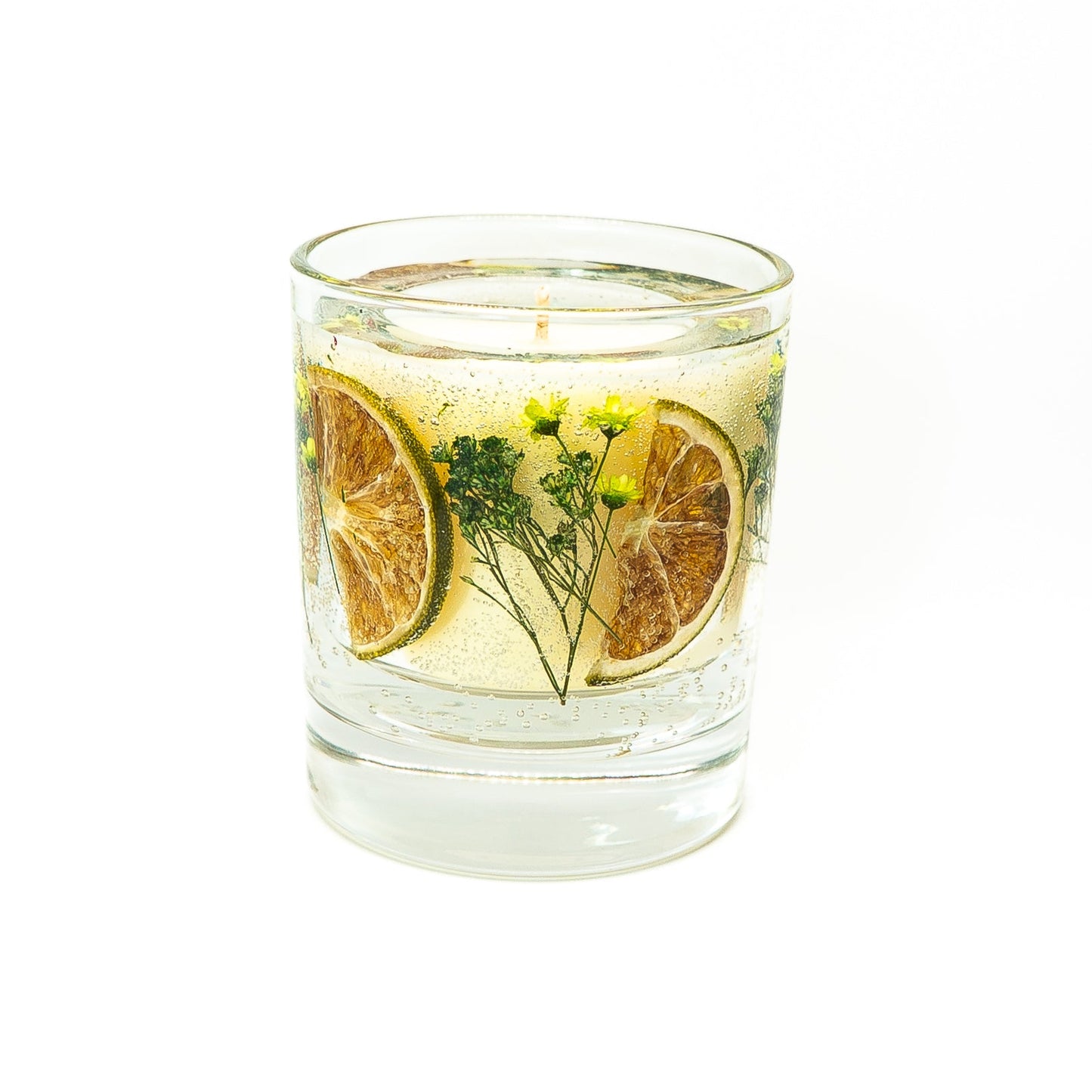 Soy wax candle with gel wax outer layer featuring dried lime slices with green botanical decorations.