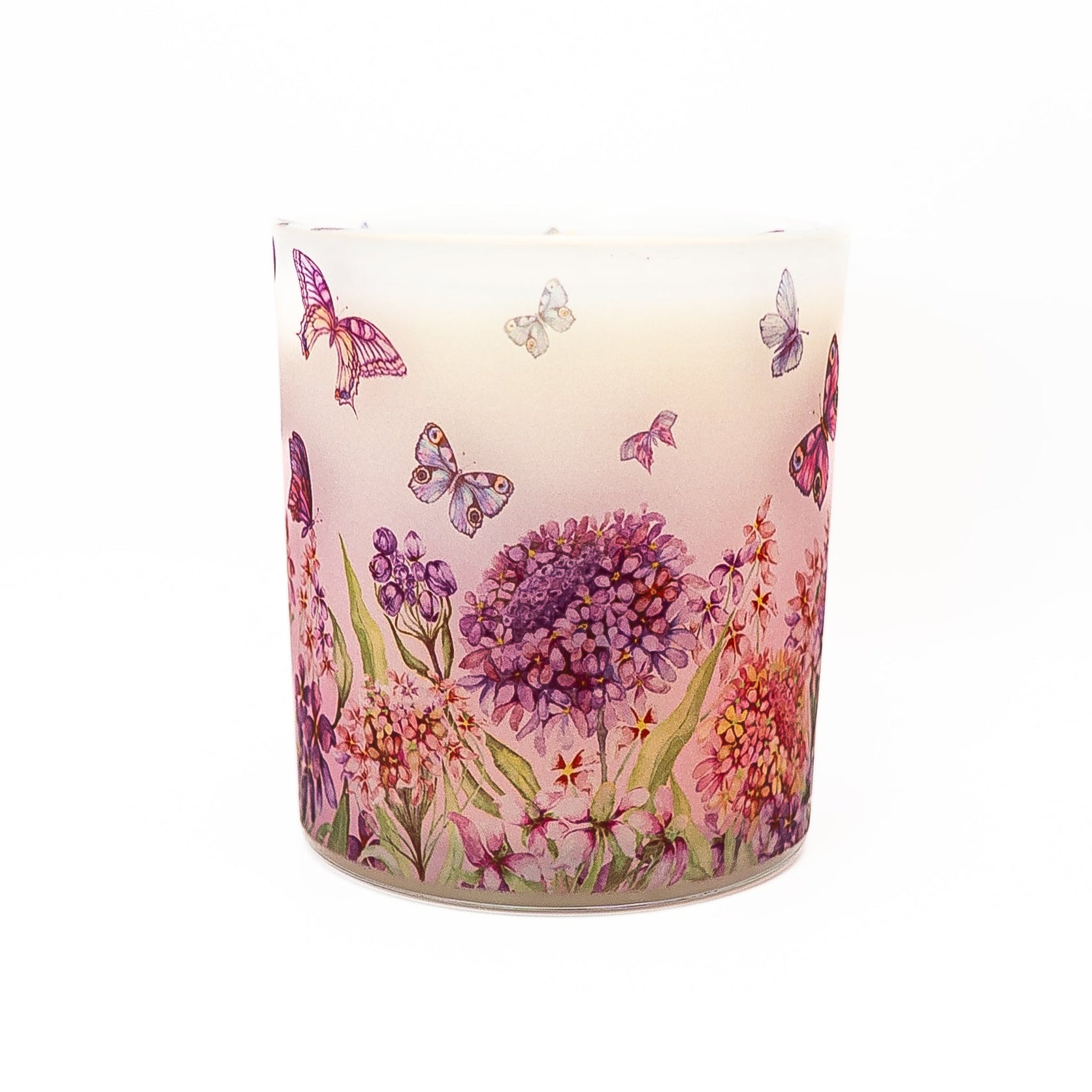 Hand-poured soy wax candle with butterfly and floral pattern in frosted glass container with bamboo lid.
