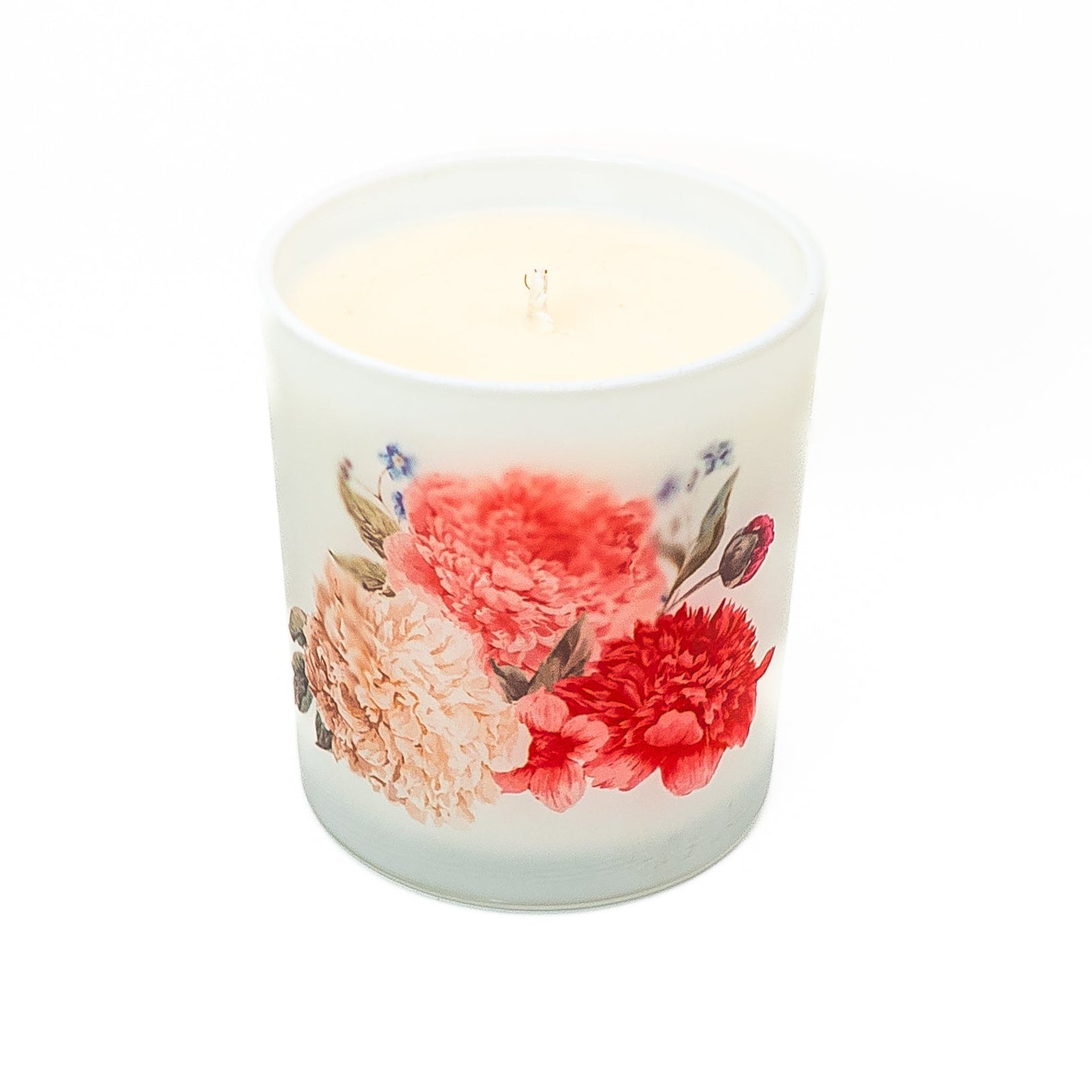 Decorative hand-poured soy wax candle in a frosted glass jar with botanical floral design.