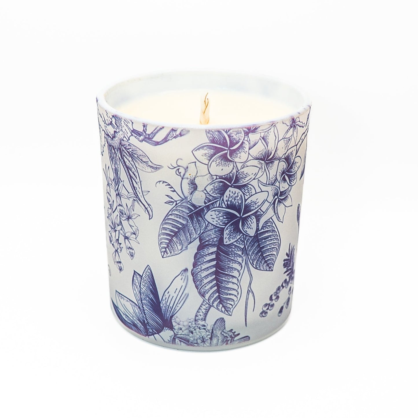 Hand-poured soy wax candle in a glass jar with blue botanical illustrations and bamboo lid.