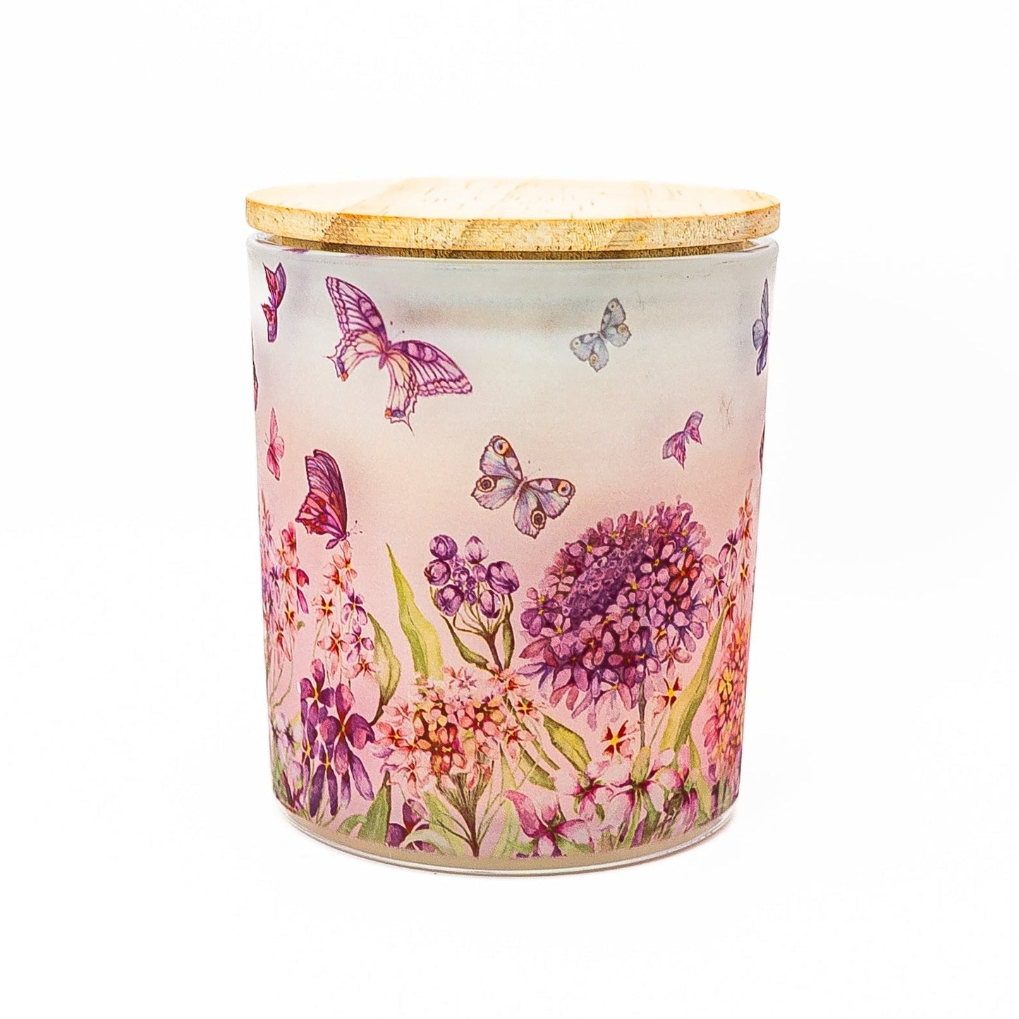 Hand-poured soy wax candle in frosted glass jar with butterfly and floral pattern and bamboo lid.