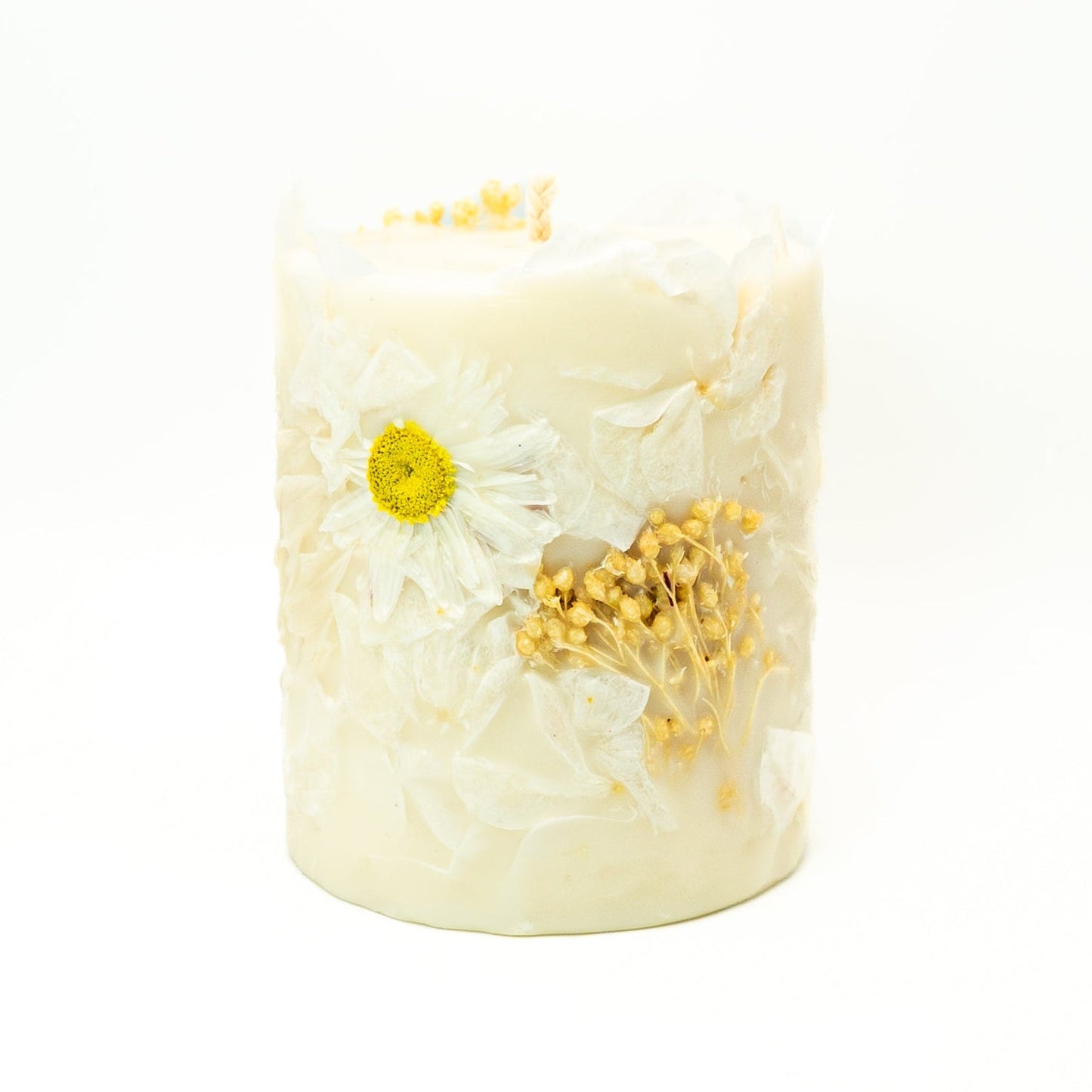 Handmade soy wax pillar candle with delicate white Acroclinium flowers embedded around the exterior.