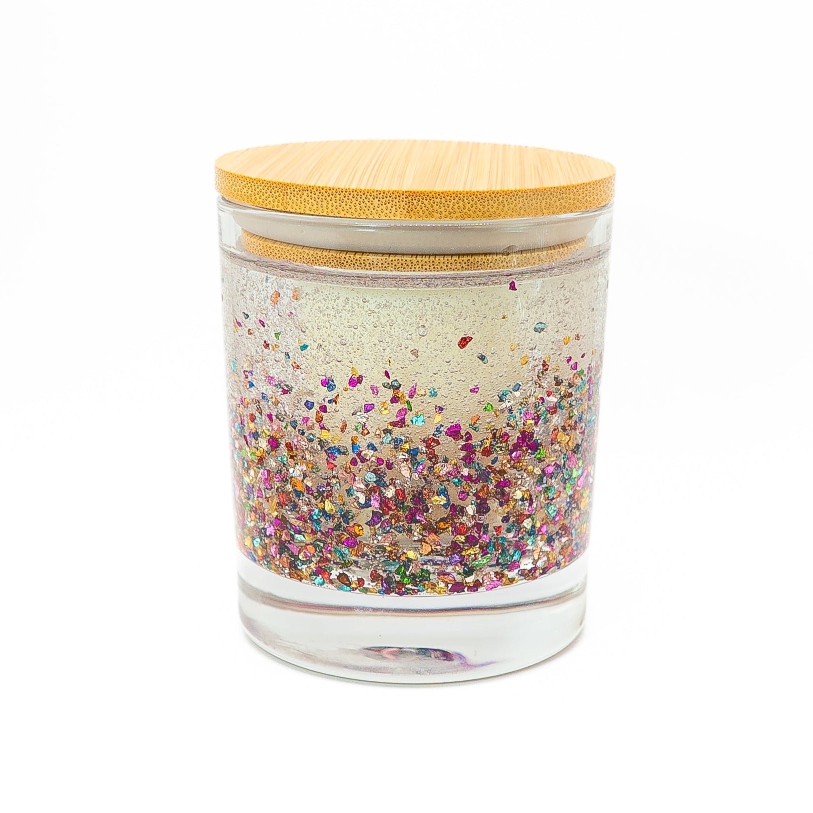 Handmade candle with sparkle glitter gel wax and soy wax center in a glass jar.