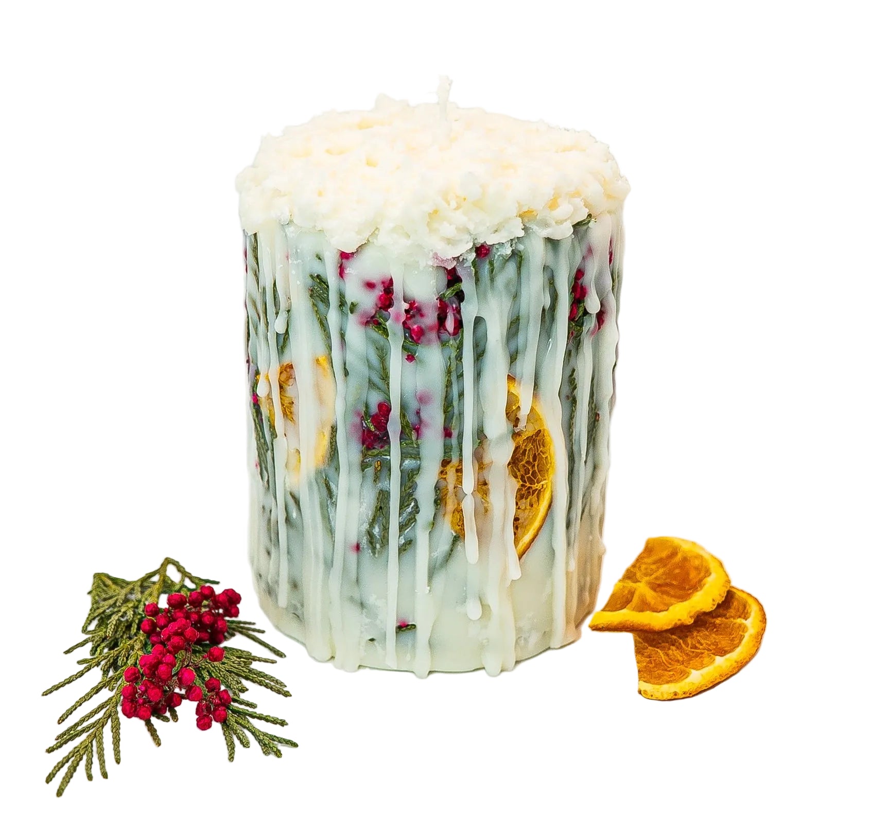 Handmade winter botanical soy wax pillar candle with dried oranges, evergreen leaves, and berries.