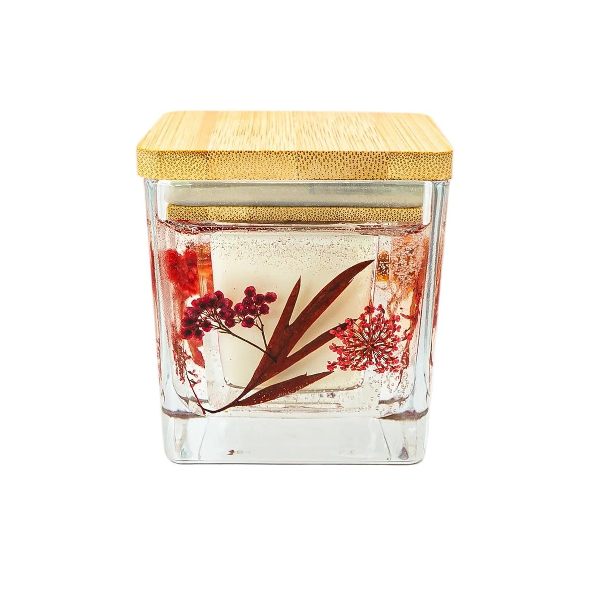 Botanical candle decorated with dried maple leaf and autumn flowers