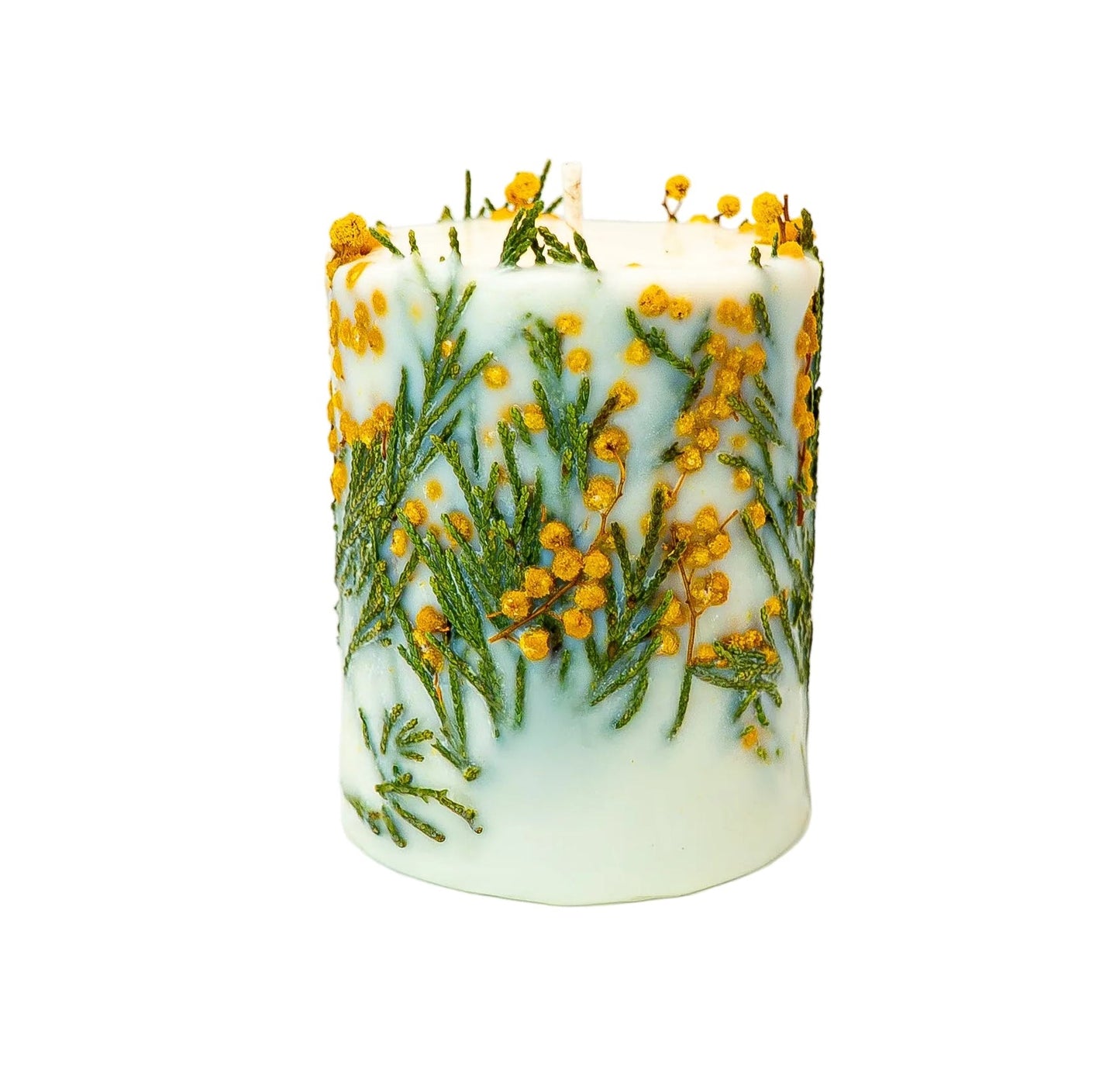 Cylindrical white soy wax candle featuring dried mimosa flowers and green fern pressed into the wax
