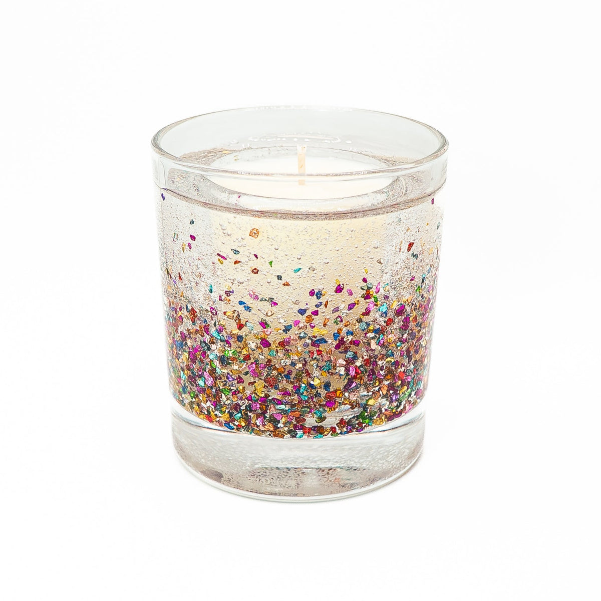 Front view of a Christmas glitter candle with colourful flecks suspended in clear gel around a soy wax centre.