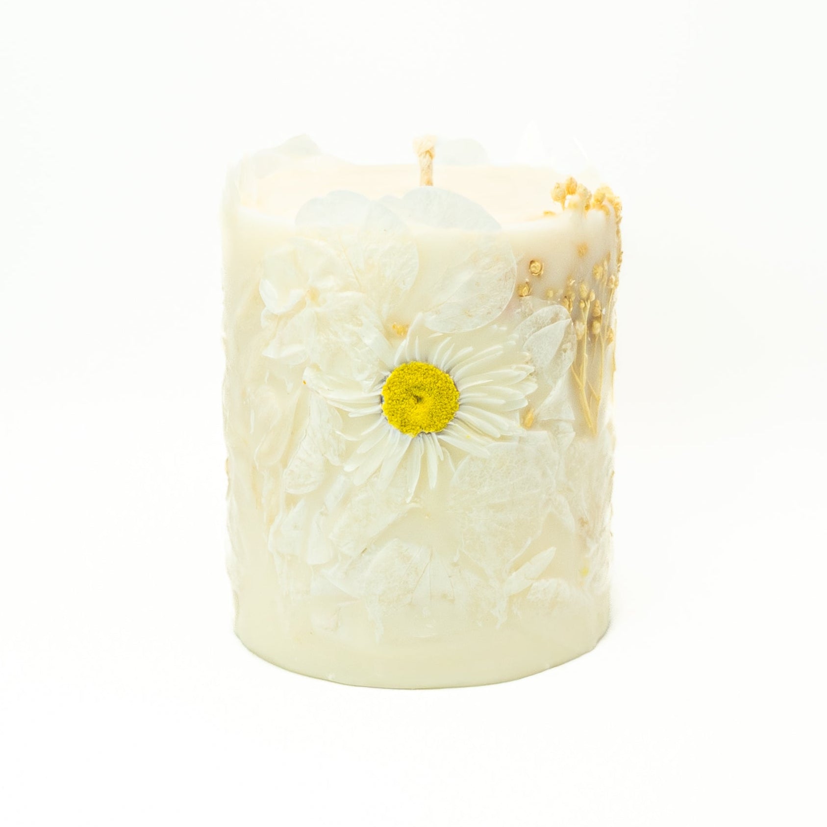 Natural soy wax pillar candle decorated with dried white Acroclinium flowers for elegant décor.
