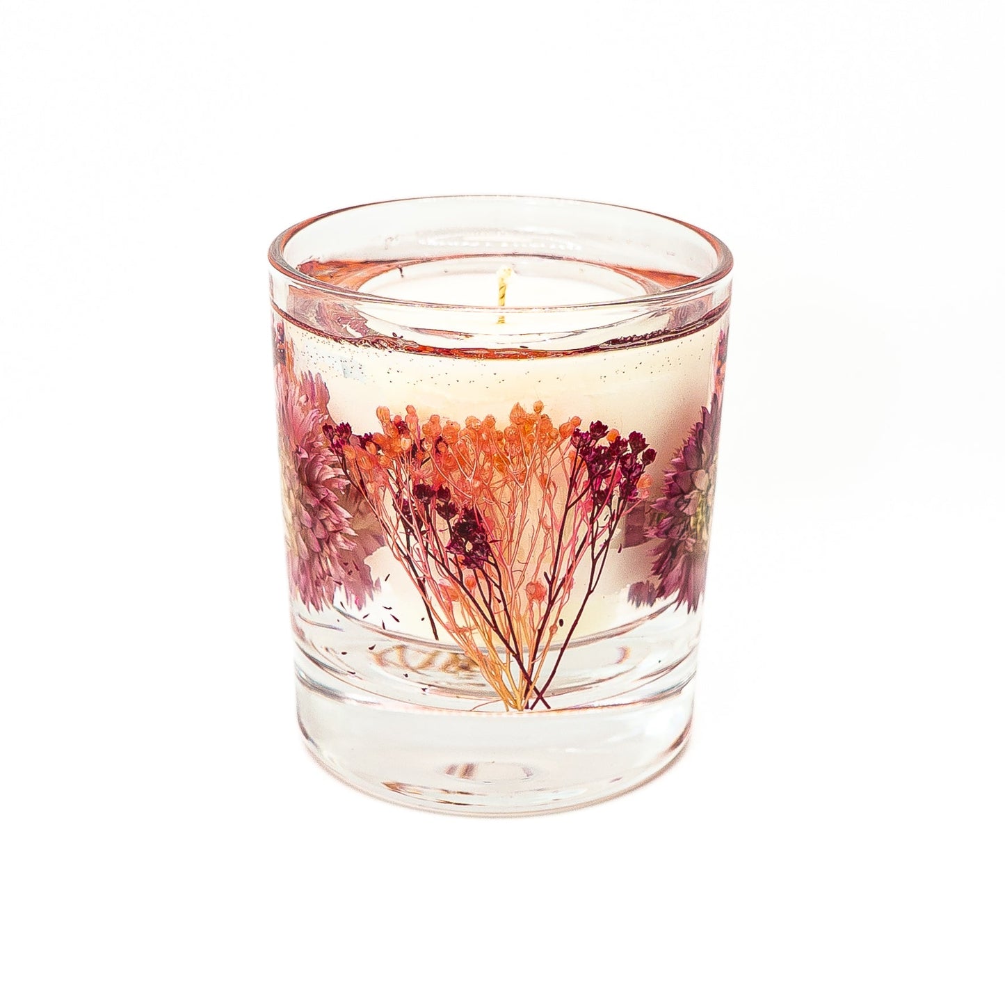 Decorative candle with soy wax center and gel wax outer layer featuring a pink helichrysum flower.