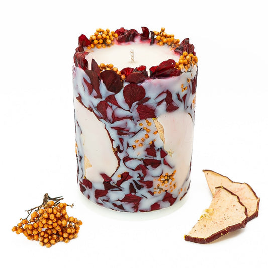Hand-poured soy wax botanical pillar candle with dried hydrangea petals and red apple slices.