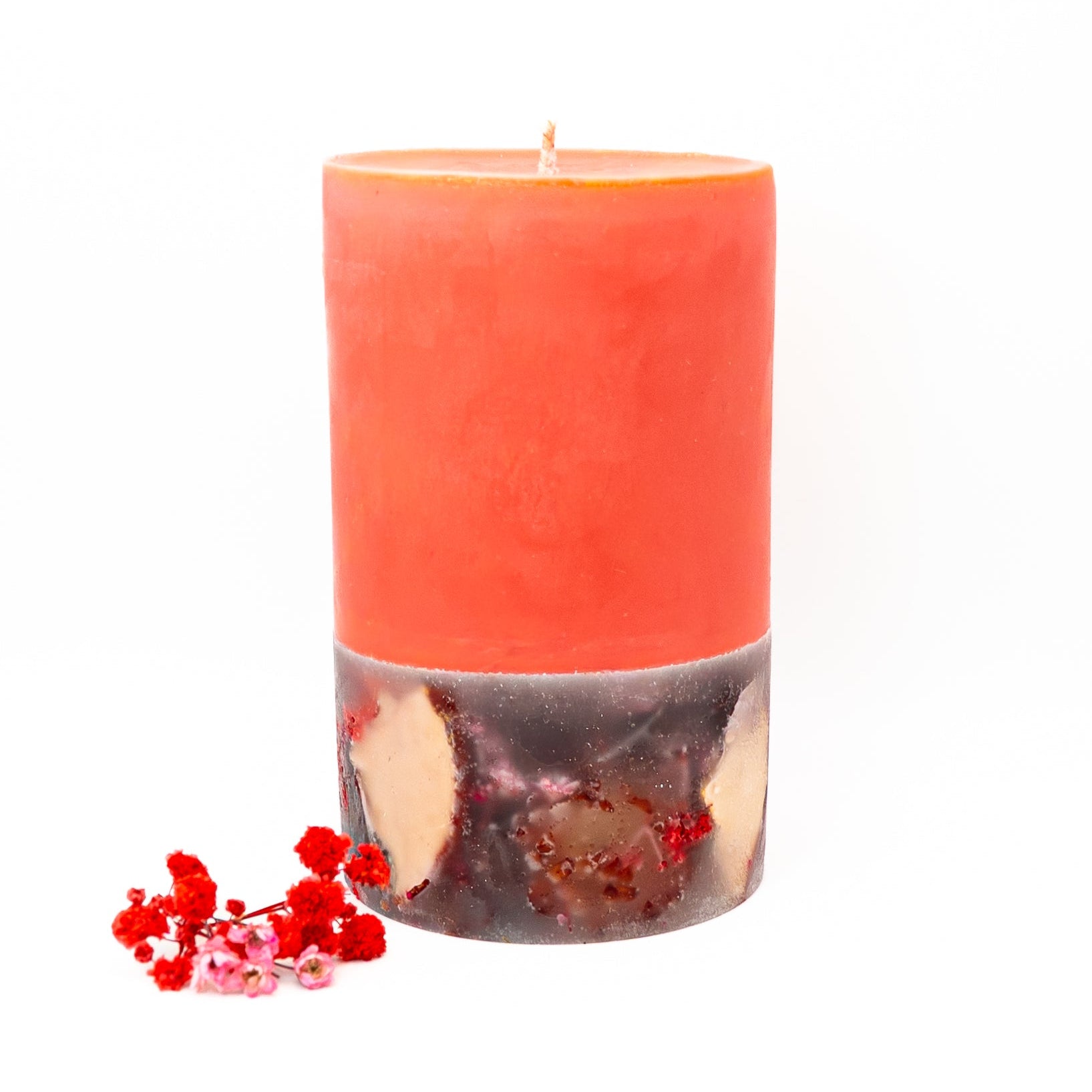 Hand-poured layered soy wax candle with red top and dried floral botanicals in the base.