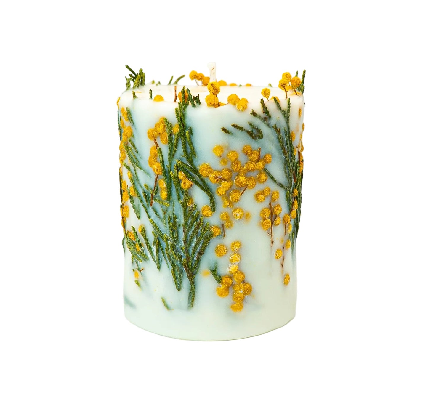 Cylindrical white soy wax candle featuring dried mimosa flowers and green fern pressed into the wax